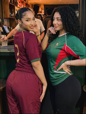AI-generated image of two women in Portugal and maroon soccer jerseys at a bar