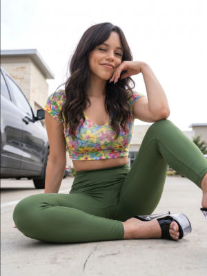 Deepfake of Jenna Ortega seated in a parking lot
