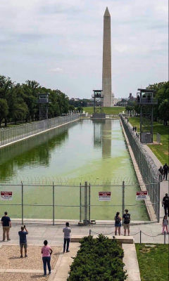 AI-generated image of the Washington Monument and Reflecting Pool fenced off with guard towers