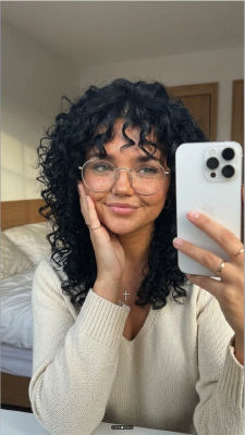 AI-generated selfie of an unidentified woman in a bedroom mirror