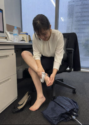 AI-generated image of a woman wiping her foot in an office