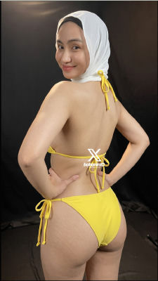 AI-generated image of a woman in a yellow bikini and white hijab