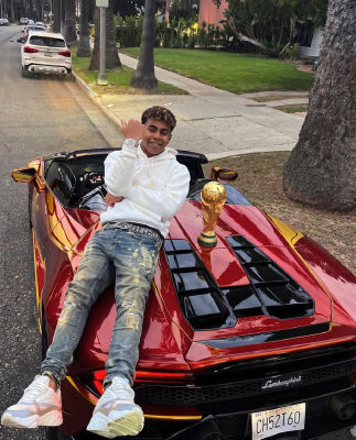 AI-generated image of Lamine Yamal with a World Cup trophy on a red Lamborghini
