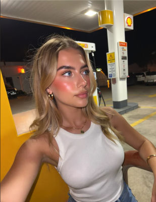 AI-generated image of a woman at a Shell gas station at night