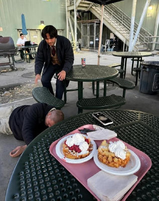 AI image detected of Justin Bieber laying down at an outdoor restaurant