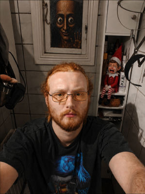 AI-generated selfie of an unidentified red-haired man with glasses in a bathroom