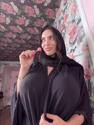AI-generated portrait of a woman in a black hijab holding a pink lollipop