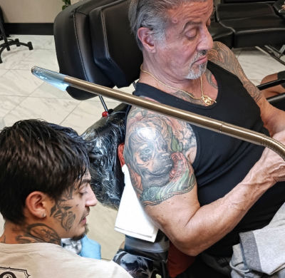 AI-generated image of Sylvester Stallone receiving a tattop