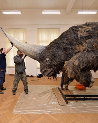 AI-generated image of a fabricated Elasmotherium reconstruction with handlers