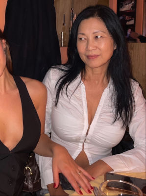 AI generated image of an unidentified woman seated at a restaurant