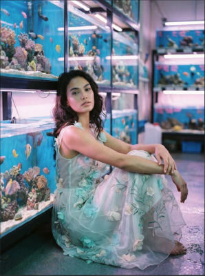 AI-generated image of a woman in a floral dress at an aquarium