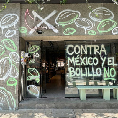 AI-generated image of Richard Hart's Green Rhino cafe vandalized with political graffiti