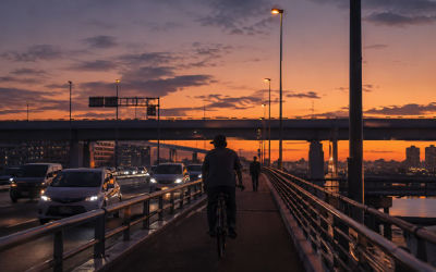 AI-generated image of a cyclist at sunset on an urban overpass