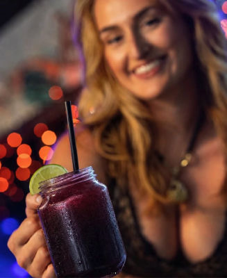 AI-generated image of a woman holding a purple cocktail at a bar