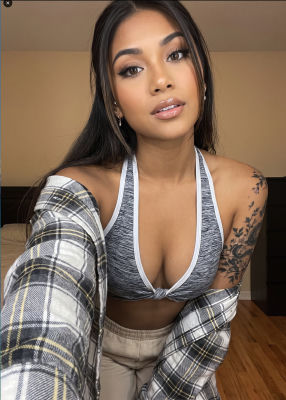 AI-generated selfie of a woman in a plaid flannel and sports bra