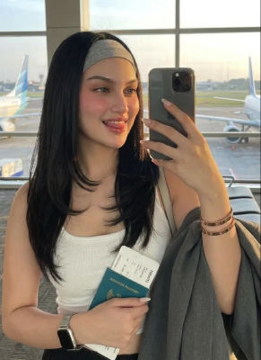 AI-generated image of a woman holding an Indonesian passport at an airport