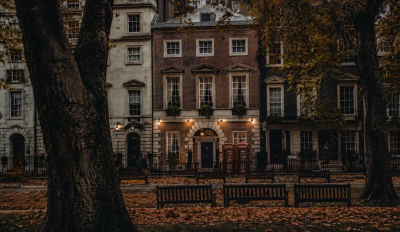 AI-generated image of a London street with red telephone booths and autumn leaves
