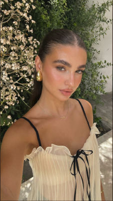 AI-generated image of an unidentified woman in a fitted top outdoors