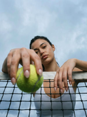 AI-generated image of a woman holding a tennis ball at a tennis net
