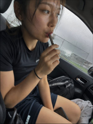 AI-generated image of a young woman applying lipstick in a car