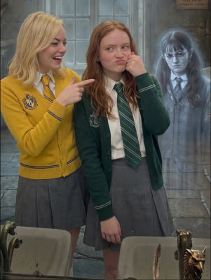 AI-generated image of Sadie Sink and Emma Stone in Hogwarts uniforms with Moaning Myrtle