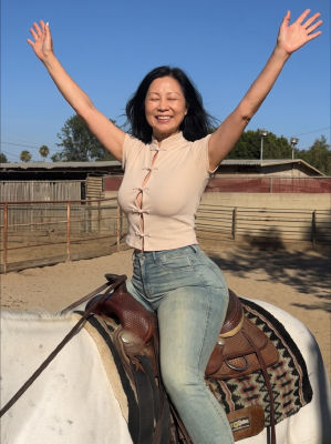 AI-generated image of a woman celebrating on horseback in a corral