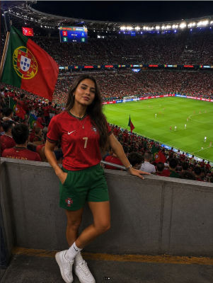 AI-generated image of a woman in a Portugal jersey at a Portugal vs Uruguay match