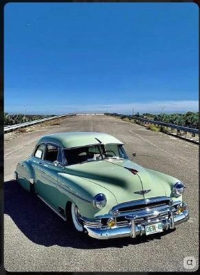 AI-generated image of a vintage green Chevrolet on an empty desert road