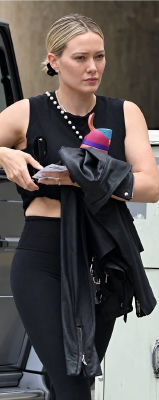 AI-generated image of Hilary Duff in black athleisure holding a water bottle