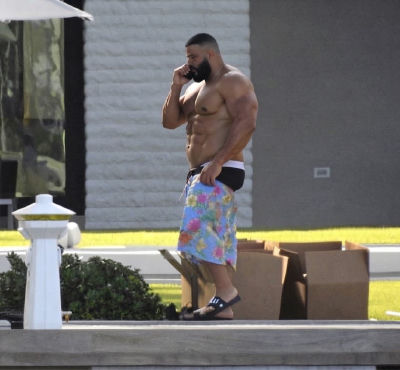 AI-generated image of DJ Khaled in floral swim trunks with six pack abs