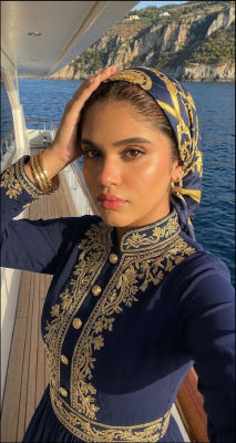 AI-generated portrait of an unidentified woman in ornate navy and gold outfit on a yacht