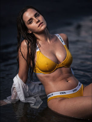 AI-generated image of Emma Watson in a yellow bikini by water