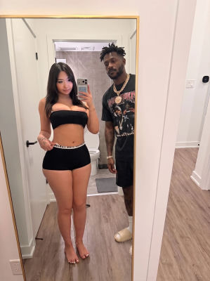 AI-generated mirror selfie showing Antonio Brown with a woman
