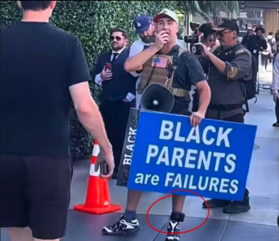 Deepfake image of Street Provocateur with a sign 