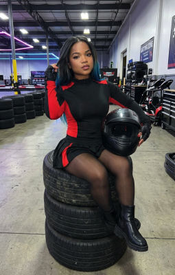 AI-generated image of a woman in racing attire at a karting venue