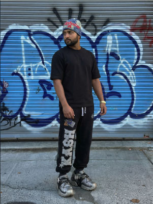 AI-generated image of a man in streetwear standing before a graffiti-covered shutter