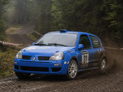 AI-generated image of a blue Renault Clio rally car on a dirt road