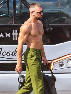 AI-generated image of Travis Kelce shirtless walking past a tour bus