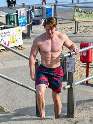 AI-generated image of a man resembling Kit Connor on a beach