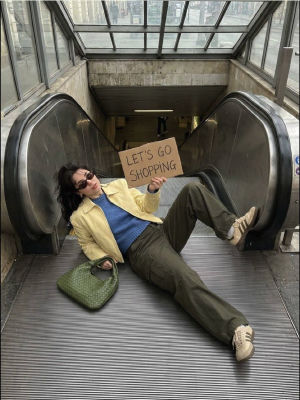 AI-generated image of a woman on an escalator holding a 'Let's Go Shopping' sign