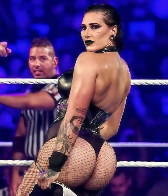 Deepfake of Rhea Ripley posing in wrestling attire inside a wrestling ring